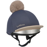 Equestrian helmet with pom-pom and LeMieux branding on a white background