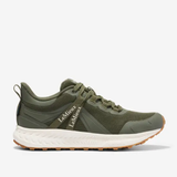 Green athletic shoe with white sole on a light grey background