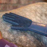 Pet grooming brush on a horse's fur with a blurred background