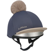 Equestrian helmet with pom-pom and LeMieux branding on a white background