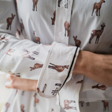 Close-up of a person wearing a white shirt with deer pattern