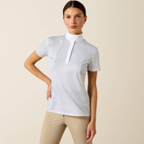 Woman wearing a white checkered shirt and beige pants on a beige background