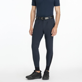 Man wearing a navy equestrian outfit on a white background