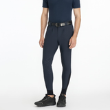 Man wearing a navy equestrian outfit on a white background