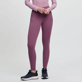 Pink riding leggings with black trainers on a grey background