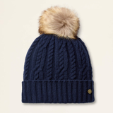 Navy blue knit beanie with a fur pom-pom on a beige background