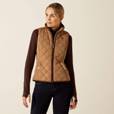 Woman wearing a brown quilted vest on a beige background