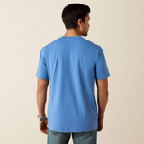 Man wearing a blue t-shirt against a beige background