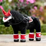 Black plush horse toy with red and white accessories in a garden setting