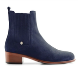 Blue suede ankle boot with a small brown heel on a white background