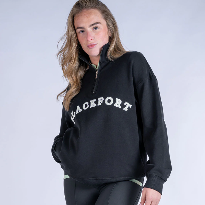Person wearing a black sweater with 'BLACKFORT' text on a plain background