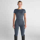 Woman wearing a grey jumpsuit on a light grey background