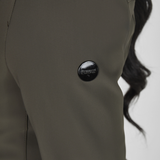 Close-up of a person wearing a green jacket with a visible brand logo on the arm.