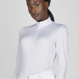 Long sleeved white show shirt on a plain background