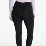 Black leggings worn by a person on a white background