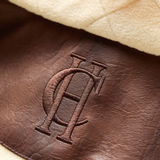 Brown leather material with HC embroidery