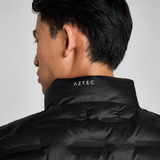 Close-up of a black gilet with AZTEC branding on a grey background