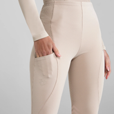 Beige breeches worn by a person on a light grey background