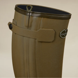 Close up of a green wellington boot with Le Chameau branding against a beige background