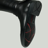 Black riding boot with a brand logo on a grey background