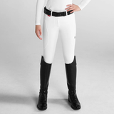 Person wearing white riding breeches on a grey background