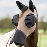 Horse wearing a black fly mask with ear extensions in an outdoor setting