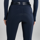 Navy blue riding breeches with a textured design on a grey background