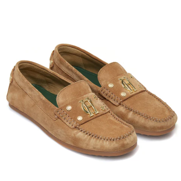 Pair of tan loafers with gold accents on a white background