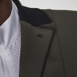 Close-up of a dark green jacket with a white shirt underneath