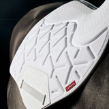 White quilted saddle pad with geometric pattern on a dark background