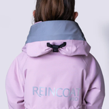 Reverse of a pink rain coat with REINCOAT branding against a white background