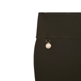 Close-up of a green legigings with a gold clasp on a white background