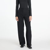 Black waterproof trousers worn against a white background