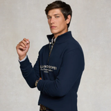 Man wearing a navy blue sweater with 'HOLLAND COOPER' branding on a light grey background