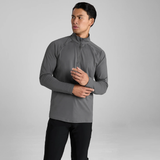 Man wearing a grey long-sleeve athletic shirt against a grey background