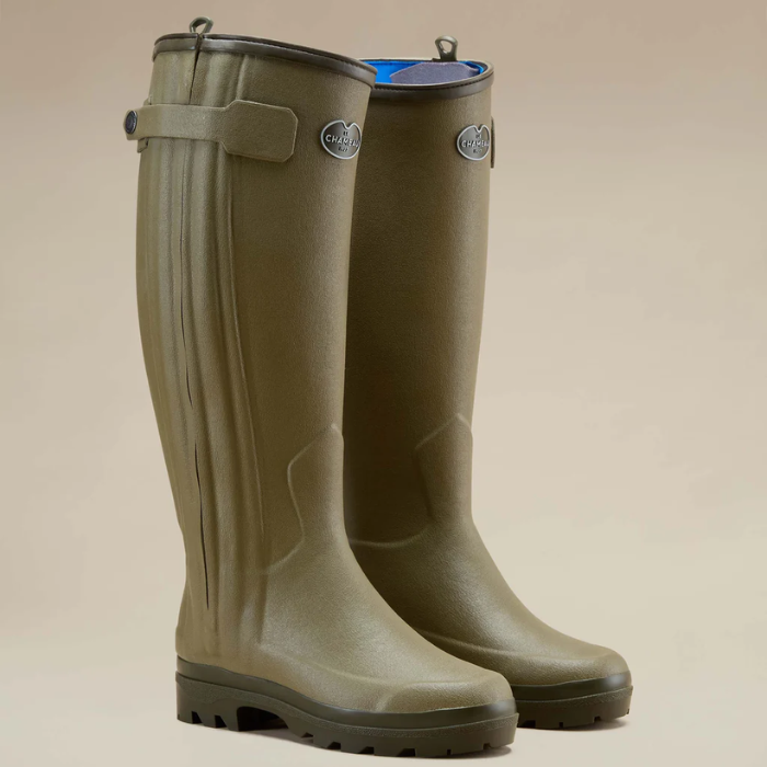 Pair of green wellington boots with Le Chameau branding against a neutral background