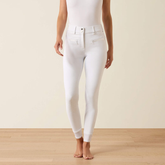 Person wears white riding breeches on a beige background