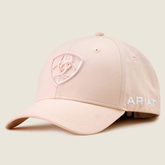 Pink baseball cap with front logo and ARIAT embroidery on the side on a beige background