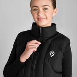 Person wearing a black puffer gilet with a brand logo on a grey background