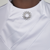 White shirt with diamante collar brooch and ruffles on a white background