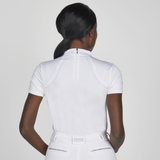 Person wearing a white equestrian shirt with short sleeves on a plain background