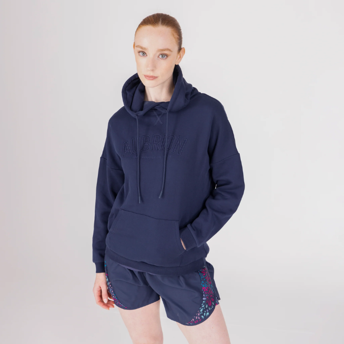 Female with blue hoodie on grey and shorts on background