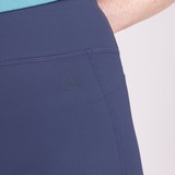 Close-up of a person wearing a blue athletic outfit with a visible brand logo on a light gray background.