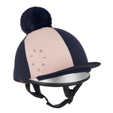 LeMieux AW26 Harlequin Hat Silk Variant Colour Navy/Petal.
A navy blue and blush pink equestrian riding helmet with a matching navy pom-pom on top, a black visor, and a silver glitter inner lining, shown against a plain white background.
