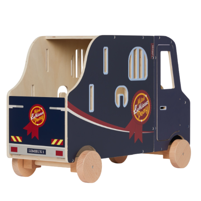 LeMieux AW26 Toy Pony Lorry Wooden Varient Brown. A wooden toy horse trailer with a dark navy blue painted exterior, natural light wood interior and wheels, and printed graphics including 'Lemieux', shown on a white background.