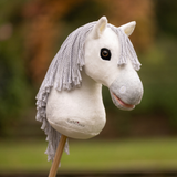 LeMieux AW26 Hobby Horse Coco Variant Colour White. A plush hobby horse on a stick with faux wool mane on faded garden background.