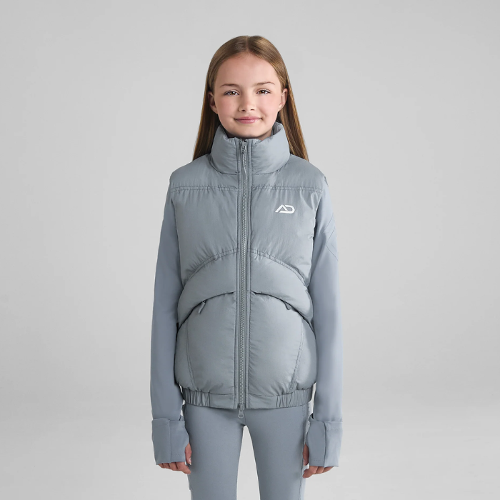 Young person wearin grey gilet on grey background
