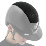 Equestrian helmet with black sponge padding on a white background