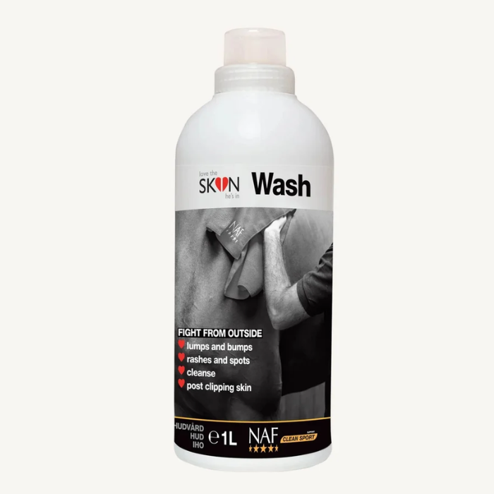 A 1-liter white bottle of Skin Wash by NAF, featuring a black and white label with a photo of a person shaving and text detailing its benefits, set against a plain off-white background.