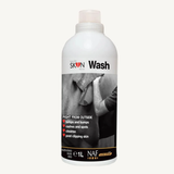 A 1-liter white bottle of Skin Wash by NAF, featuring a black and white label with a photo of a person shaving and text detailing its benefits, set against a plain off-white background.